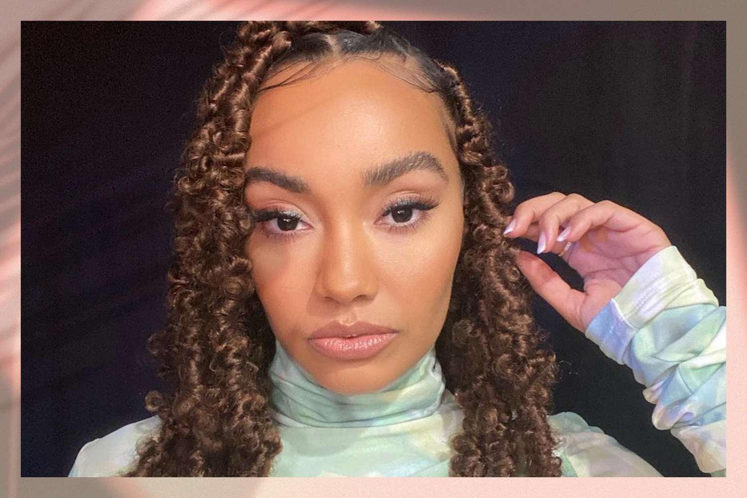 Black adult female looking into photographic camera wearing butterfly locs hairstyle