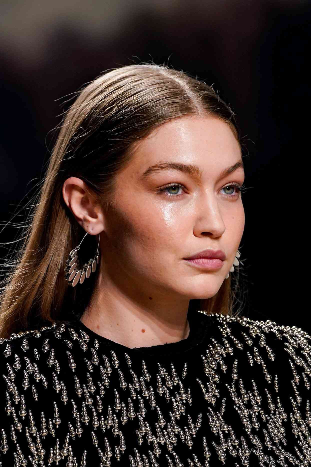 gig hadid with mushroom brown hair in beaded black top