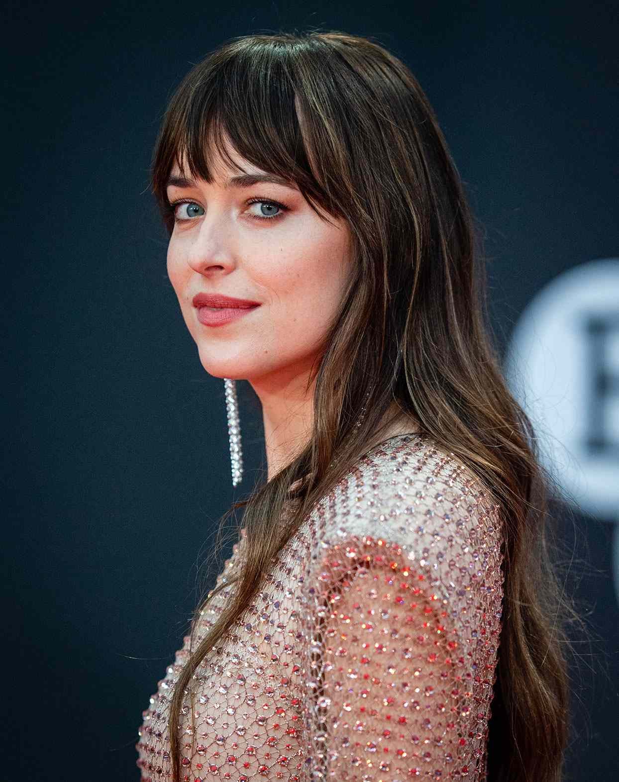 Dakota Johnson with long brunette hair at the Lost Daughter UK Premiere