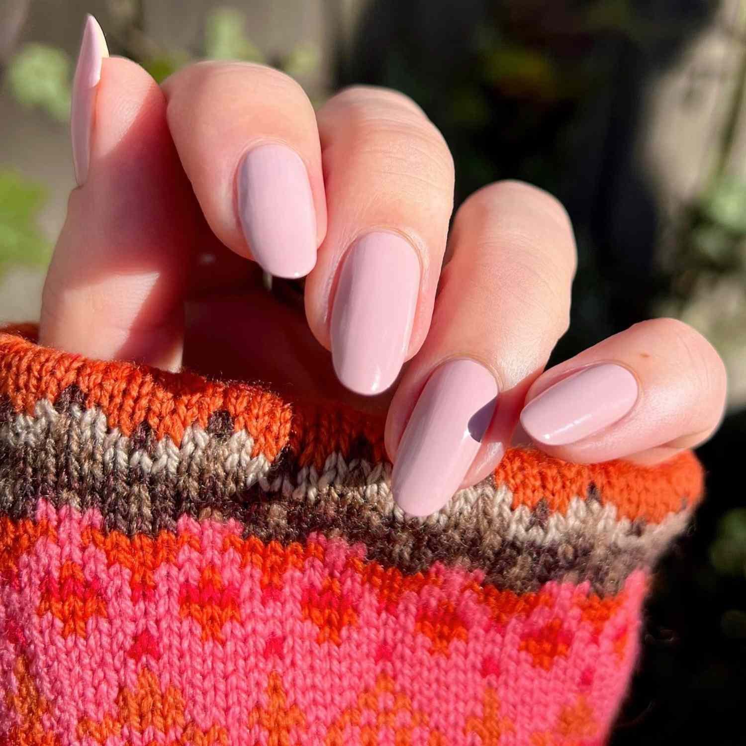 close up of nail with visible light pink manicure
