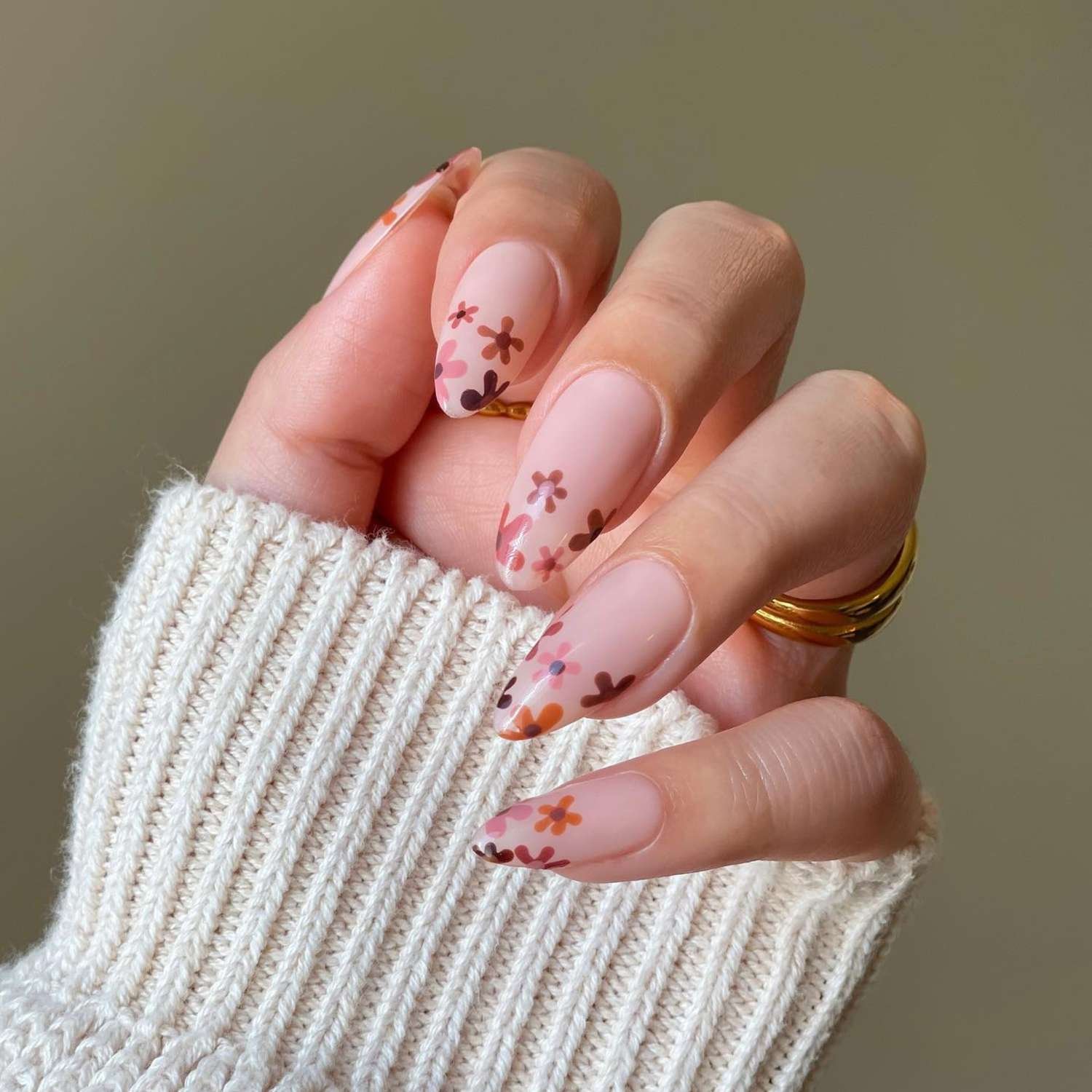 close up of nails with visible radiation pink base and flowers paint on tips