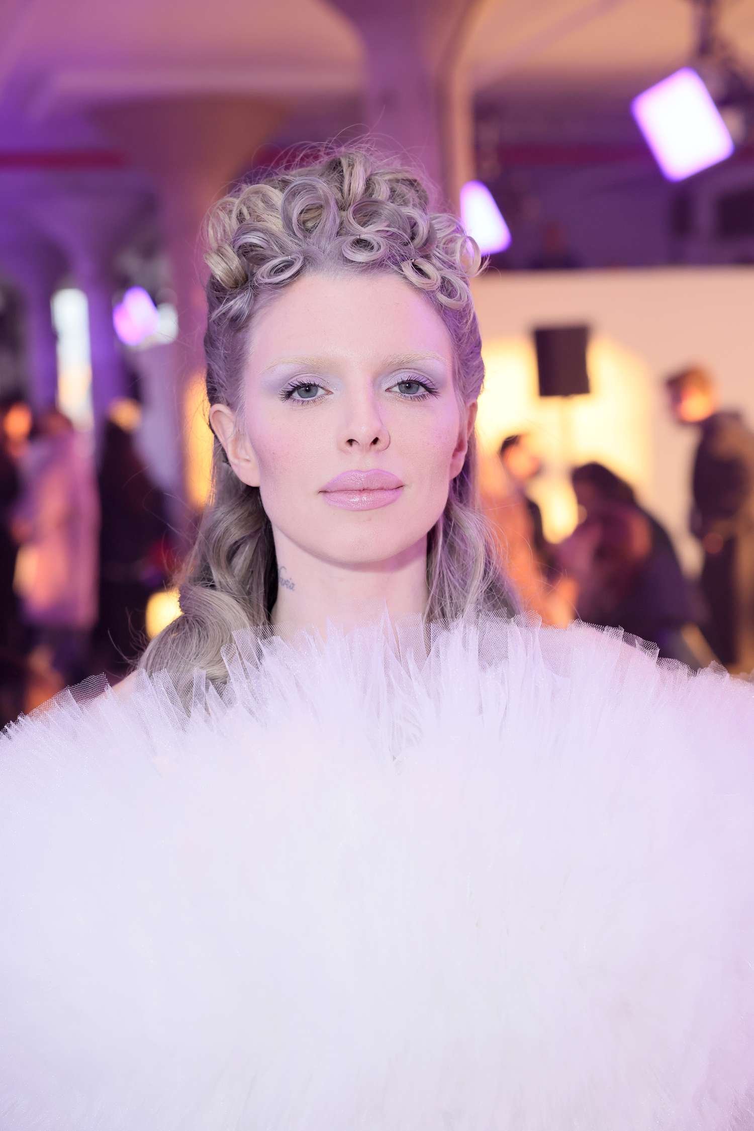 Julia Fox eating away A curled grey mullet hair style during new York Fashion Week