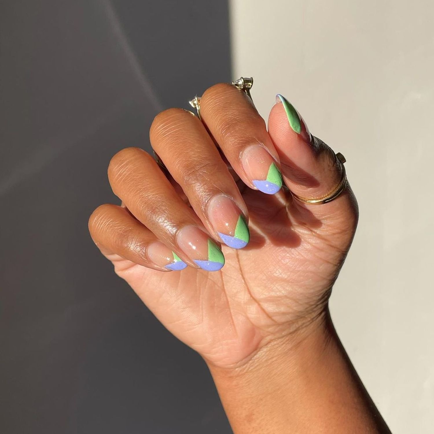 Nails paint with green and blue apex French tips and a shimmery top coat