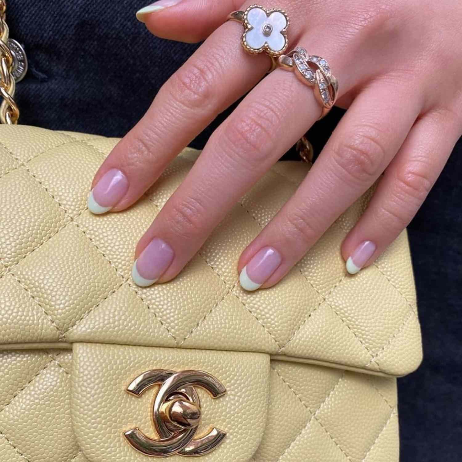 Fingers painted with a deal French manicure