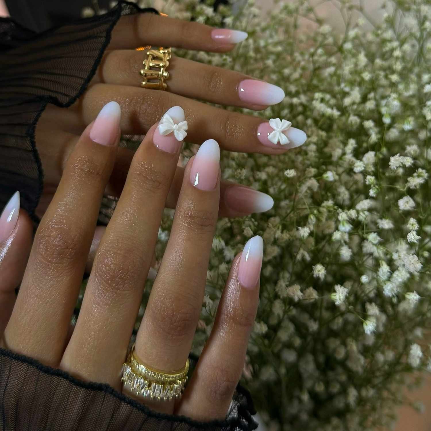 close up of nail with light pink and White ombre manicure with 3d bowknot on II nails