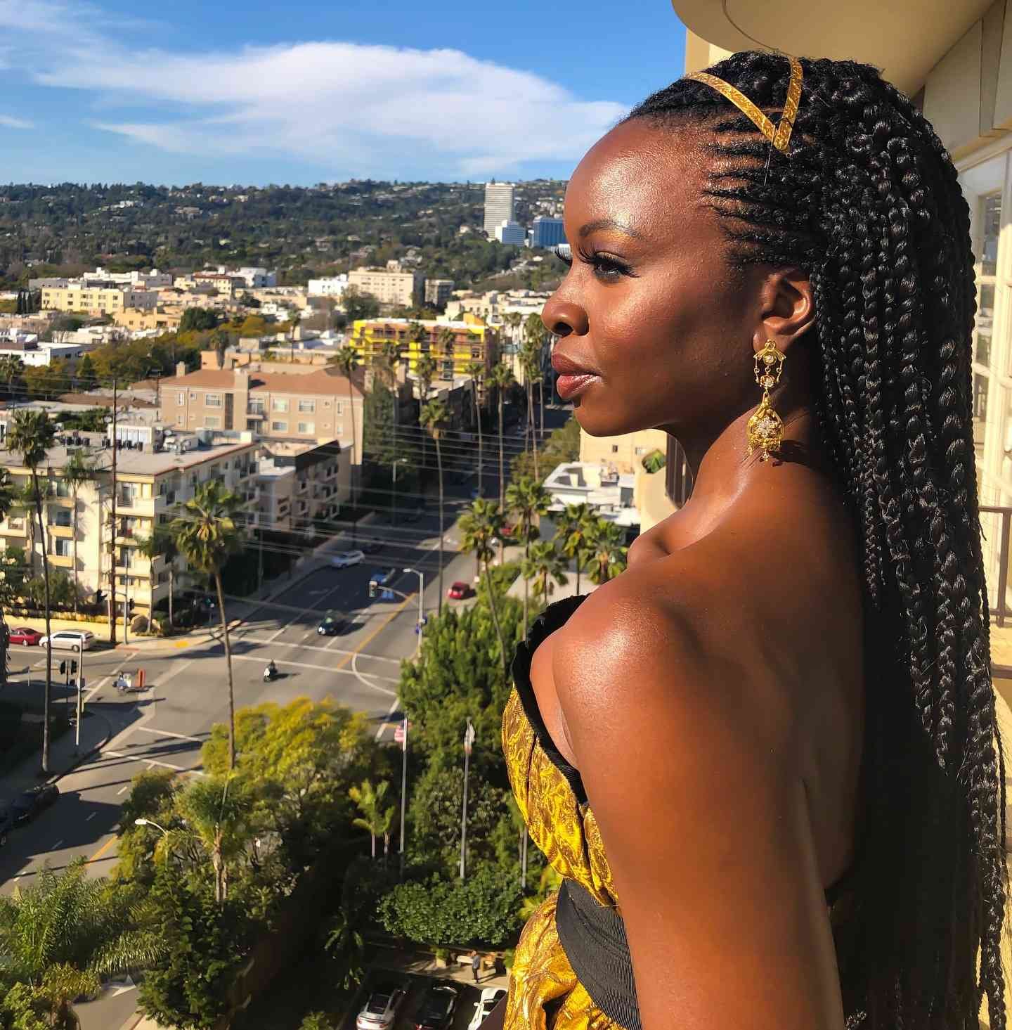 Danai Gurira with a braided Crown and a gold headpiece