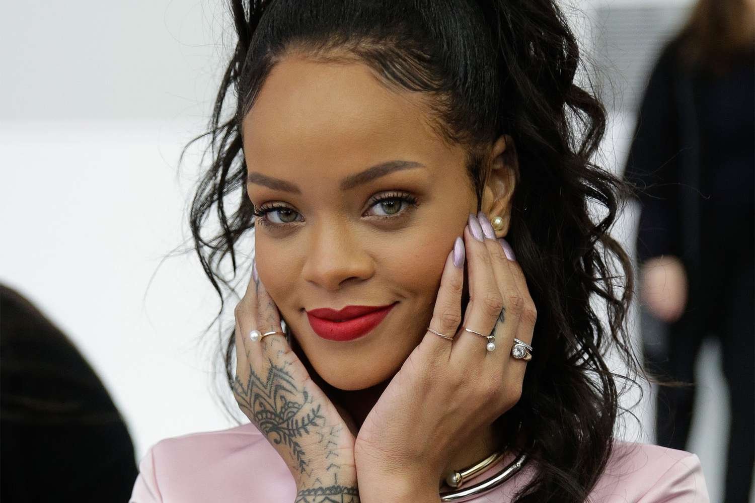 Rihanna wearing away A half-up half-down hairstyle.