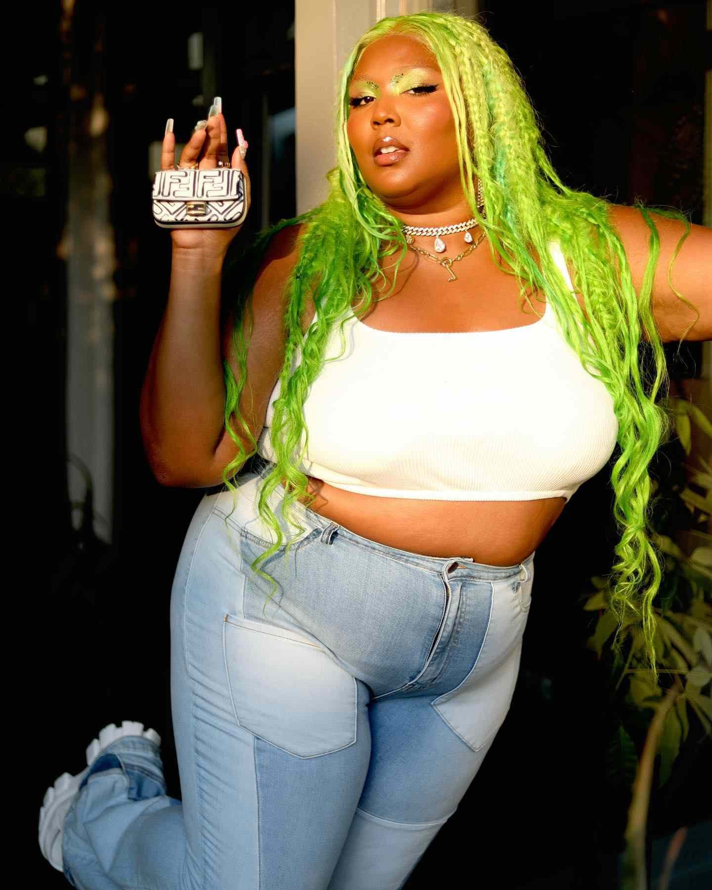 Lizzo with messy lime greenness braids