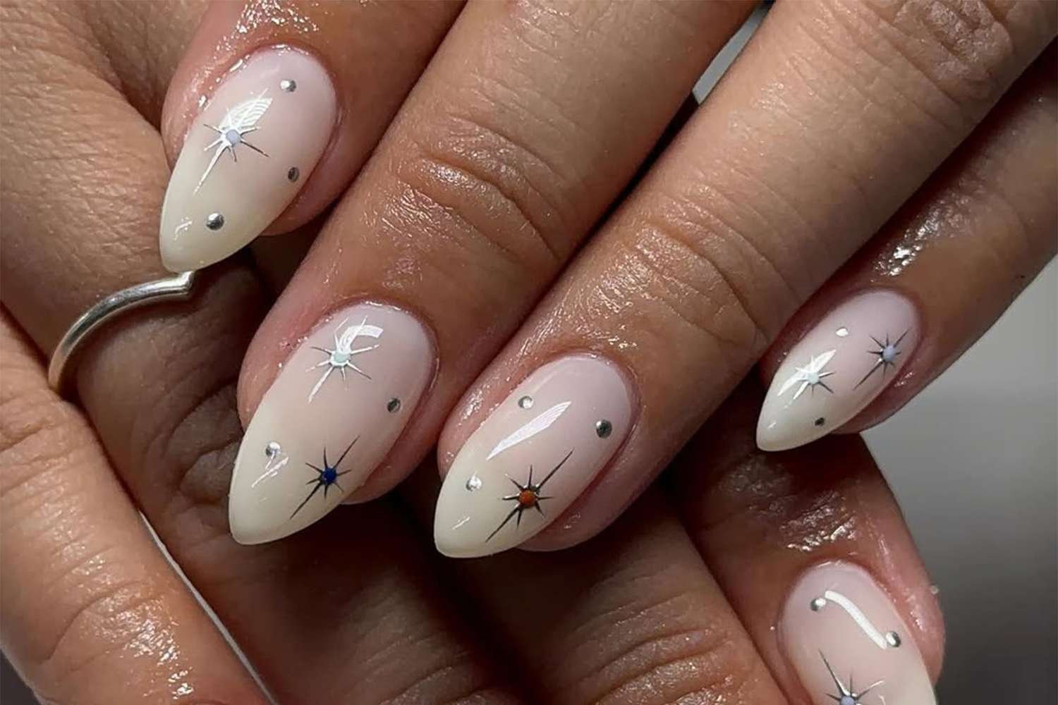 A milky white nail with silver, blue, and red accents for new Years Eve.