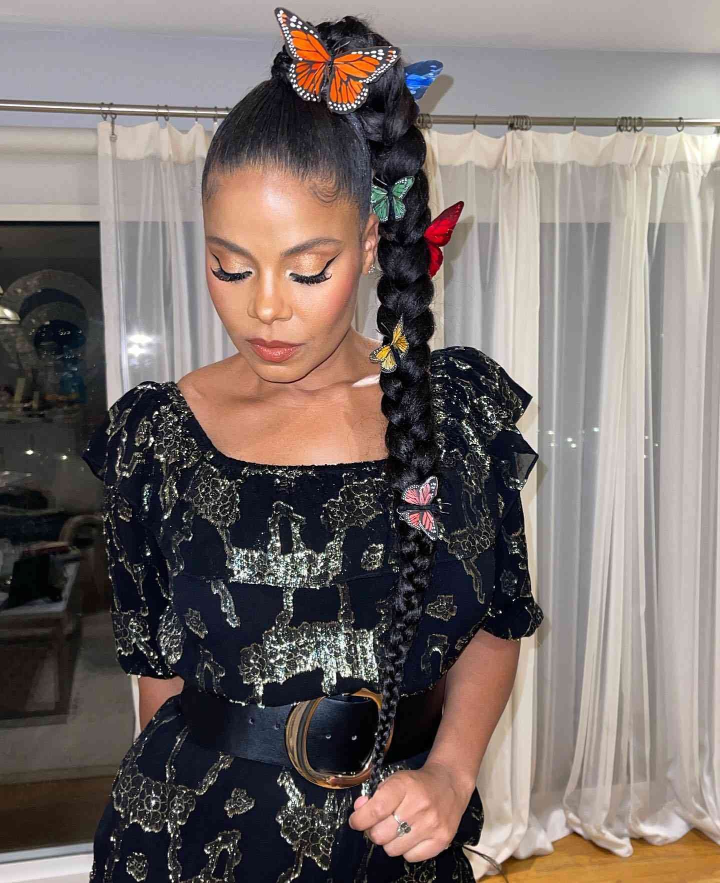 Sanaa Lathan with a lace ponytail and piebald butterfly clips