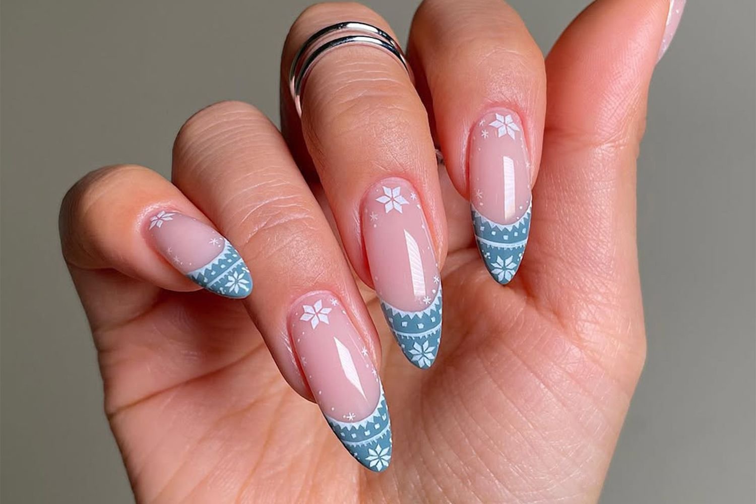 A hand-painted sweater nail design.